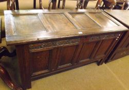 An 18th Century Oak Coffer, the four panelled top with iron hinges, void interior, four panelled