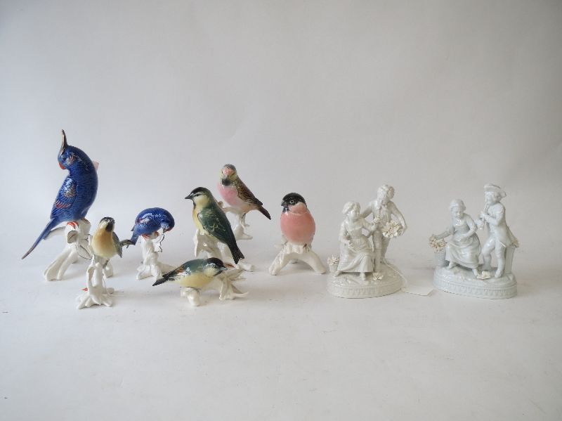 Six continental bird figures by Karl Ens and a pair of figures in the white of courting couples