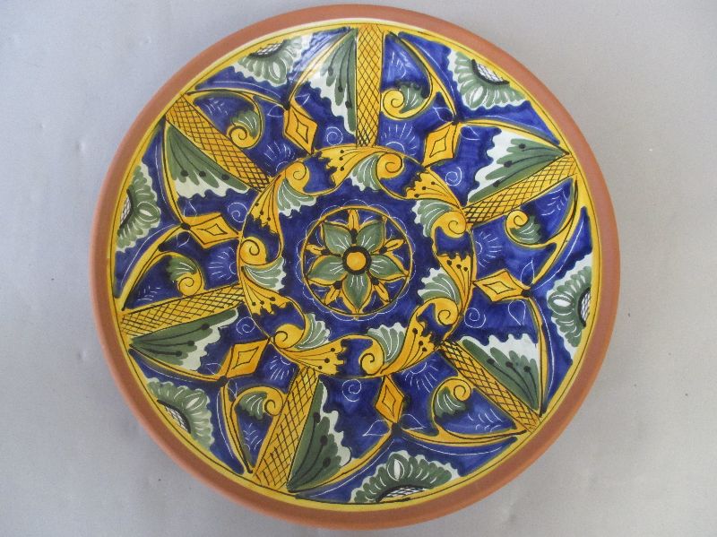 Large decorative modern terracotta charger (possibly Spanish) decorated with geometric foliage