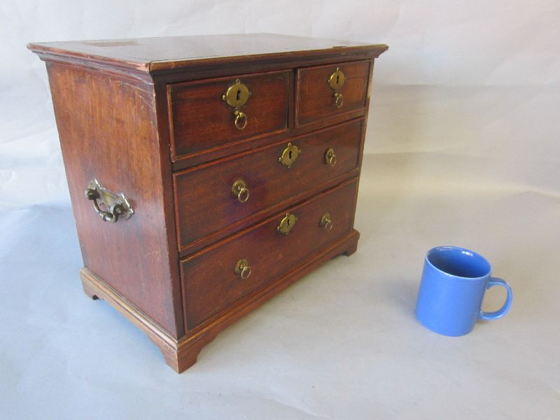 Early C19th apprentice mahogany miniature chest of two short & two long graduated drawers with brass
