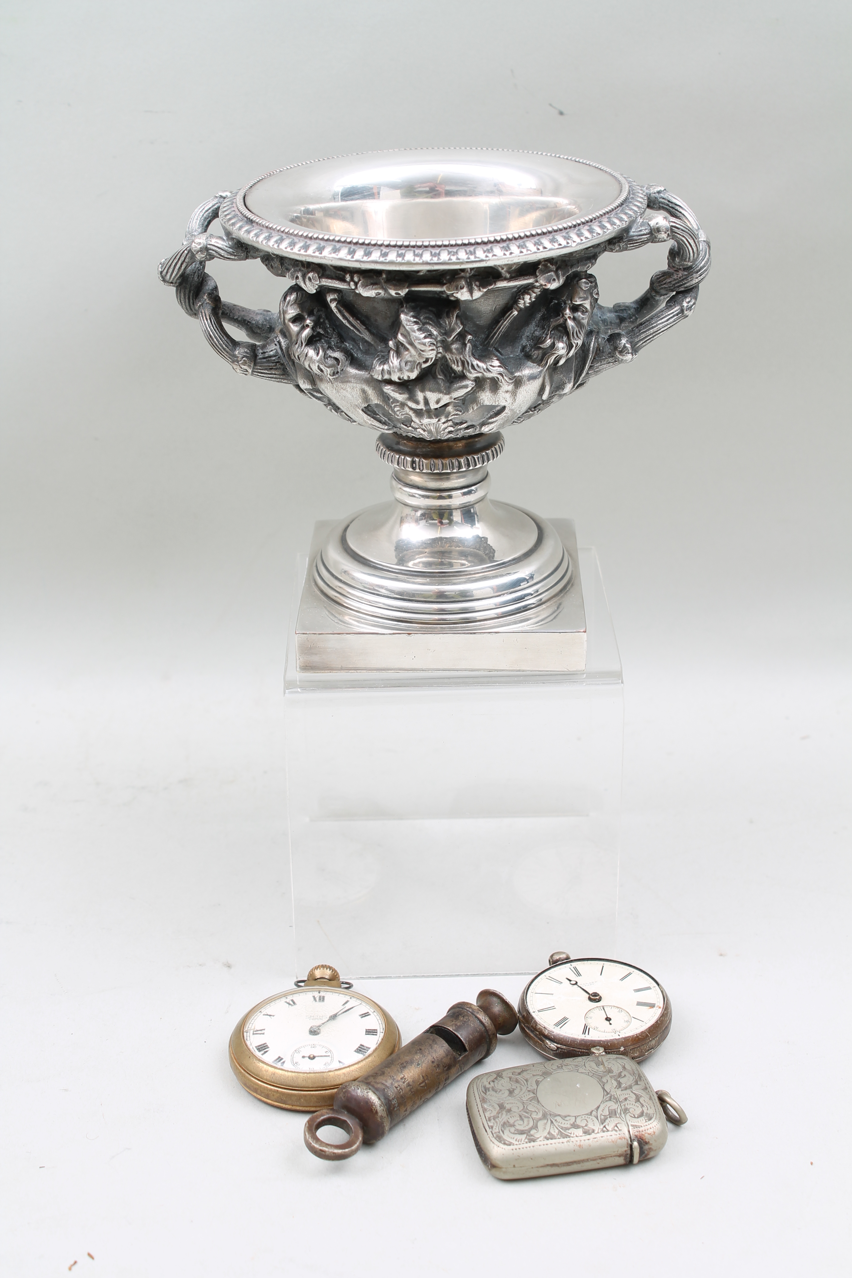 A 1914 white metal whistle by J Hudson and Co, a silver pocket watch a/f, a gold plated pocket