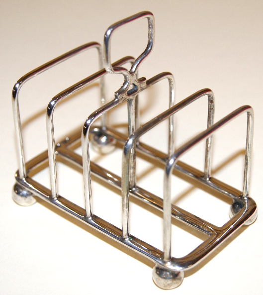 Hallmarked silver toast rack, raised on four globular supports, Sheffield assay, 1914. Maker Atkin
