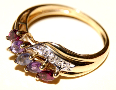 9ct yellow gold ladies' dress ring, set with five purple stones and diamond chips to the