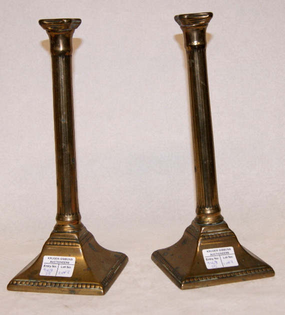 Pair of George III brass candlesticks, Corinthian column form with square pyramidal bases - each