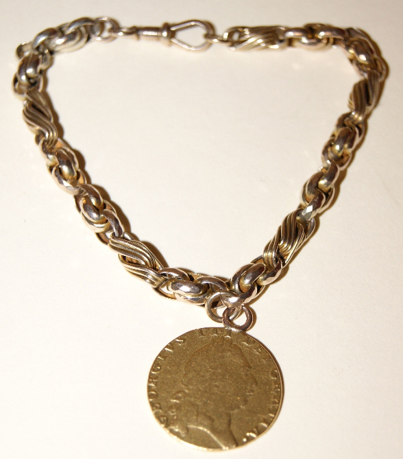 George III 'Spade' guinea, 1793, with later mount, attached to an unmarked yellow metal bracelet.