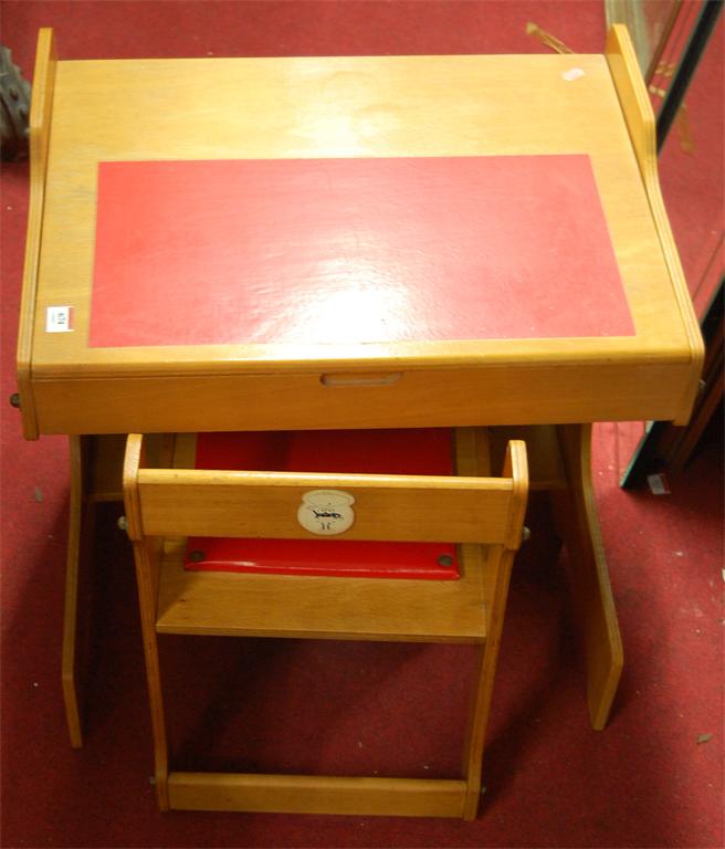 A child's plywood desk with chair