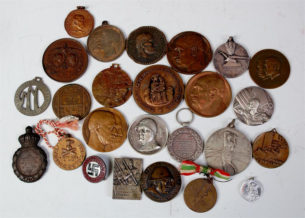 A collection of approximately 25 assorted medals, medallions and cap badges to include mainly