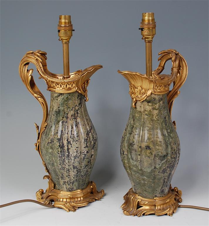 # A pair of circa 1900 gilt bronze and verdigris marble table lamps in the form of ewers, in the