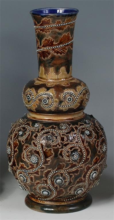 A Doulton Lambeth stoneware vase by George Tinworth, having cylindrical neck above a double gourd,