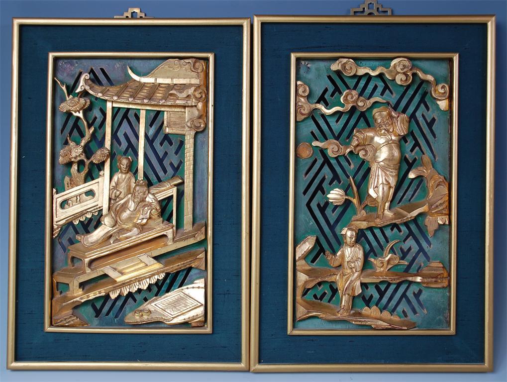 A pair of Chinese carved giltwood panels, each carved with figure scenes against pierced green