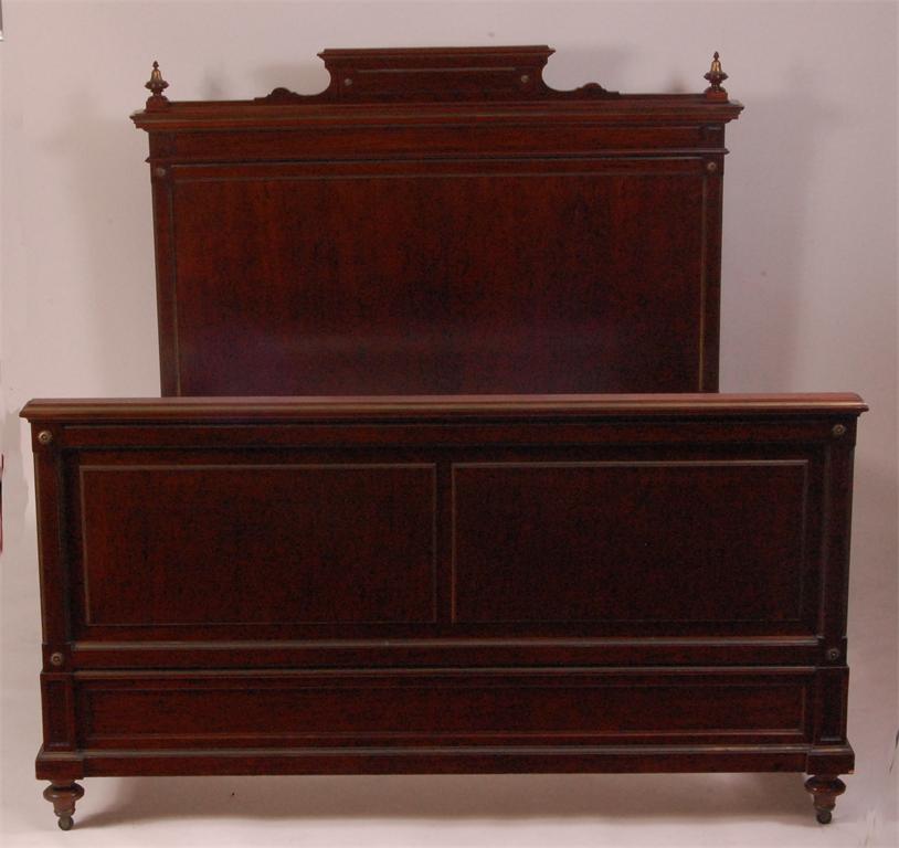 A French Empire plum pudding mahogany and brass mounted 5ft bedstead, having single panelled head,