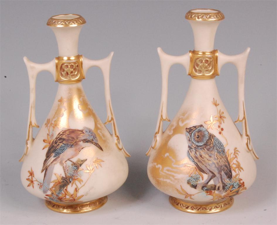 A pair of late 19th century Royal Worcester porcelain twin handled vases, enamel decorated in the