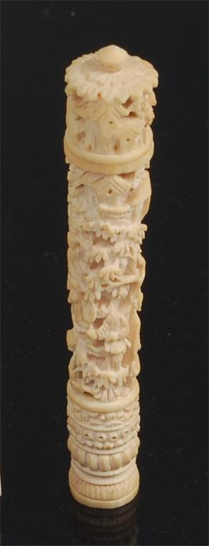 A late 19th century Chinese Canton ivory needlecase and cover, carved in relief with figure