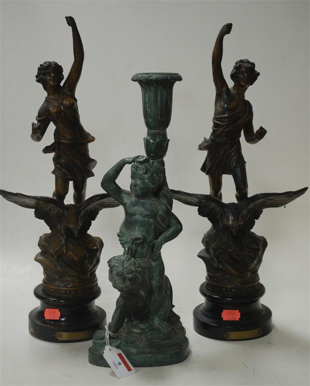 A pair of French bronze spelter figures; Day and Night, and a reproduction bronze cherub group;