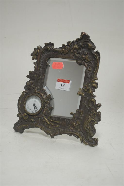 A reproduction Junghans type cast bronze metal easel dressing table mirror with inset clock