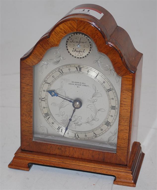 An Elliott walnut cased mantel clock retailed by Wilson & Gill of Regent Street