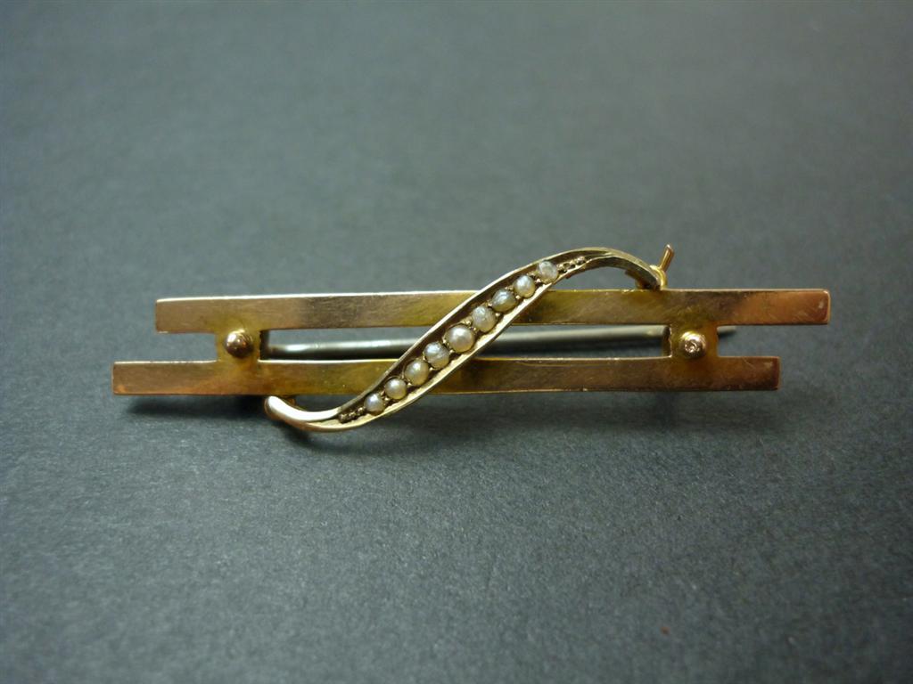 A 9ct gold and split seed pearl brooch, comprising two parallel bars joined by pellets and