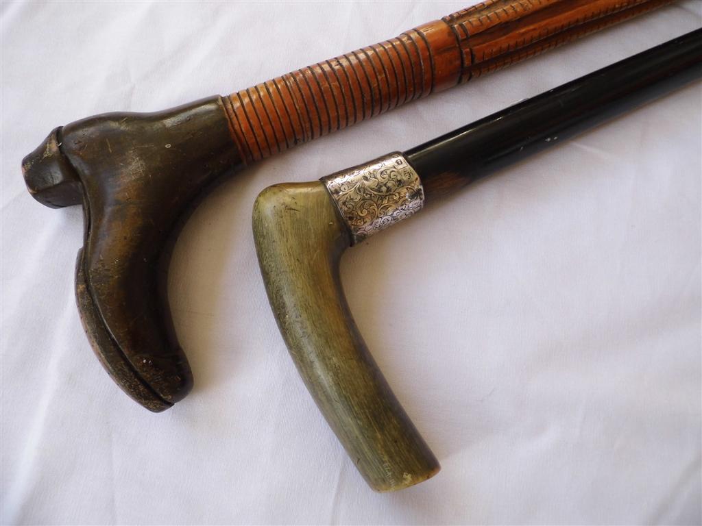 Two Victorian walking sticks, comprising a rustic example the pommel of which carved as a boot, 93