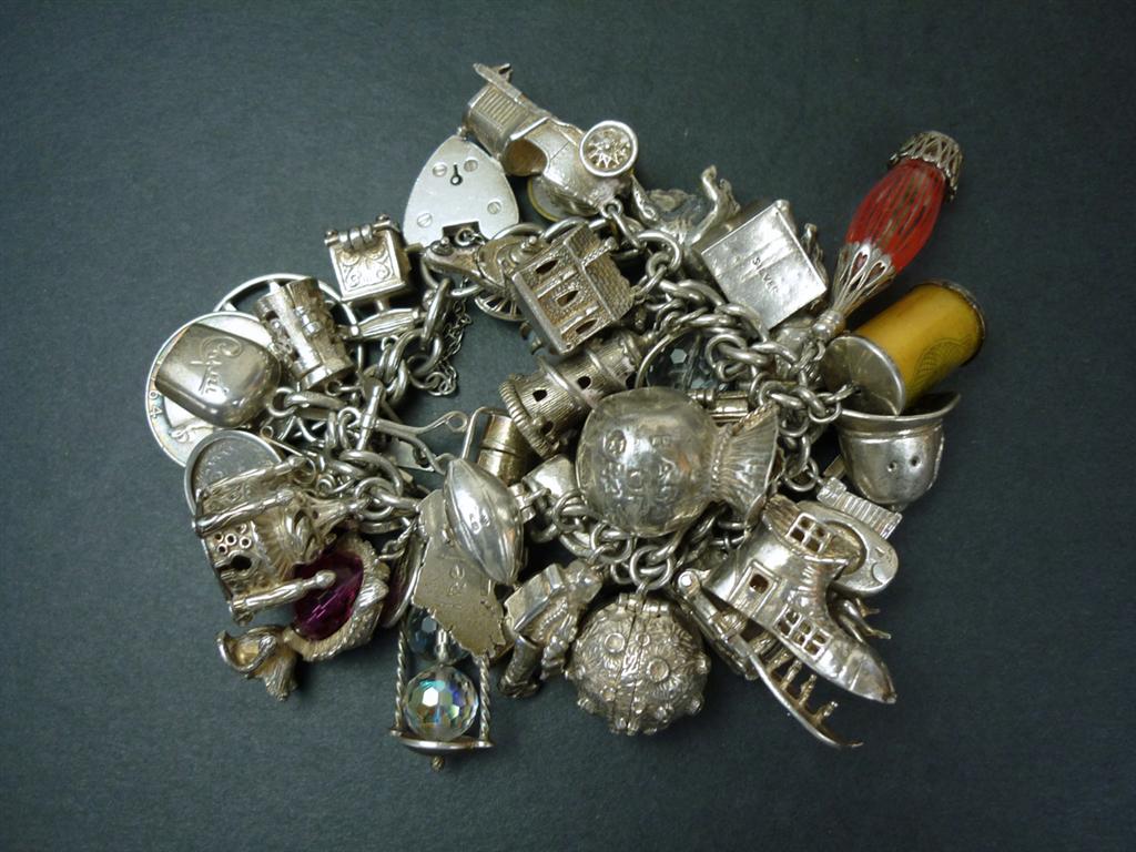 An extremely substantial silver charm bracelet, 202g