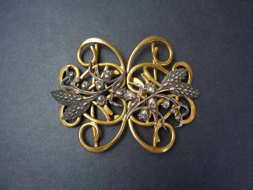 An early 20th Century lady`s Art Nouveau base metal belt buckle, in an openwork arrangement