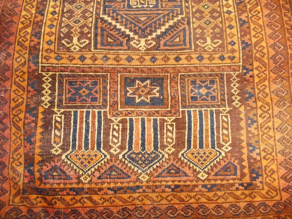 Afghan rug with twin medallion design on red ground (a/f), together with a belouch prayer rug (a/