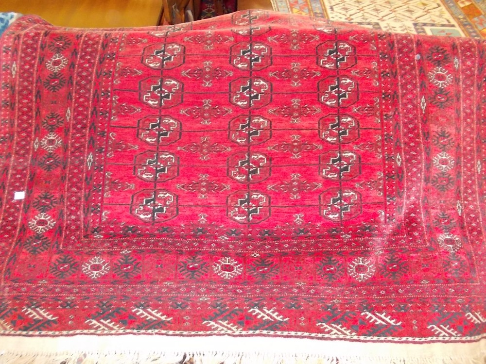 Early to mid 20th Century Tekke rug with three rows of gols on a red ground with multiple borders,