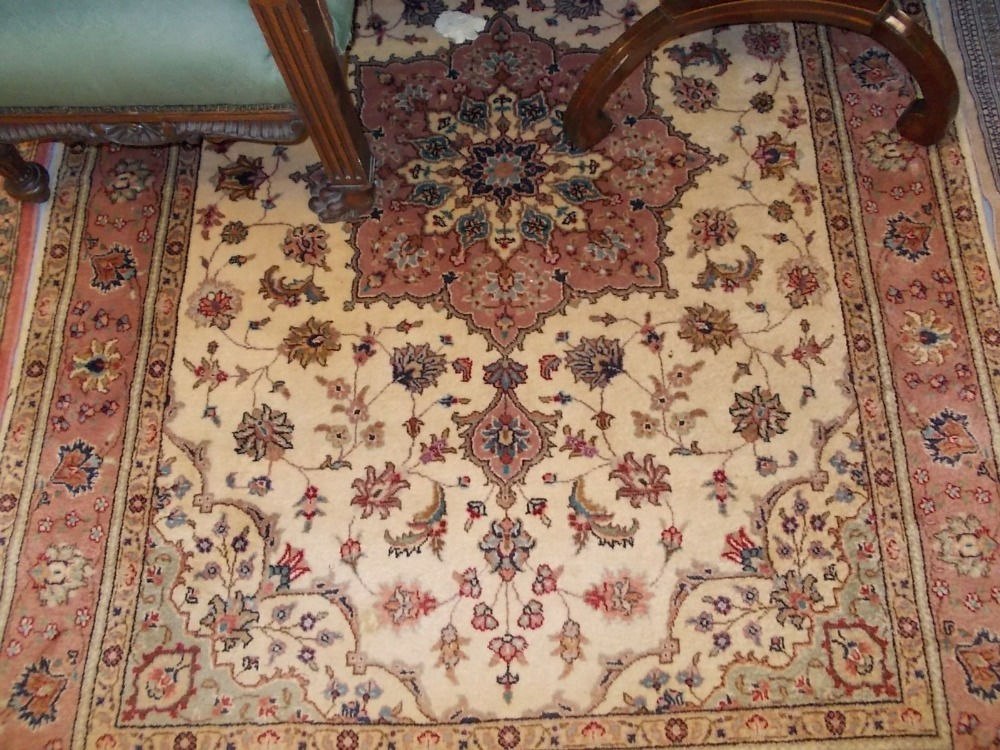 Indo Persian rug having medallion design with borders on red and cream ground