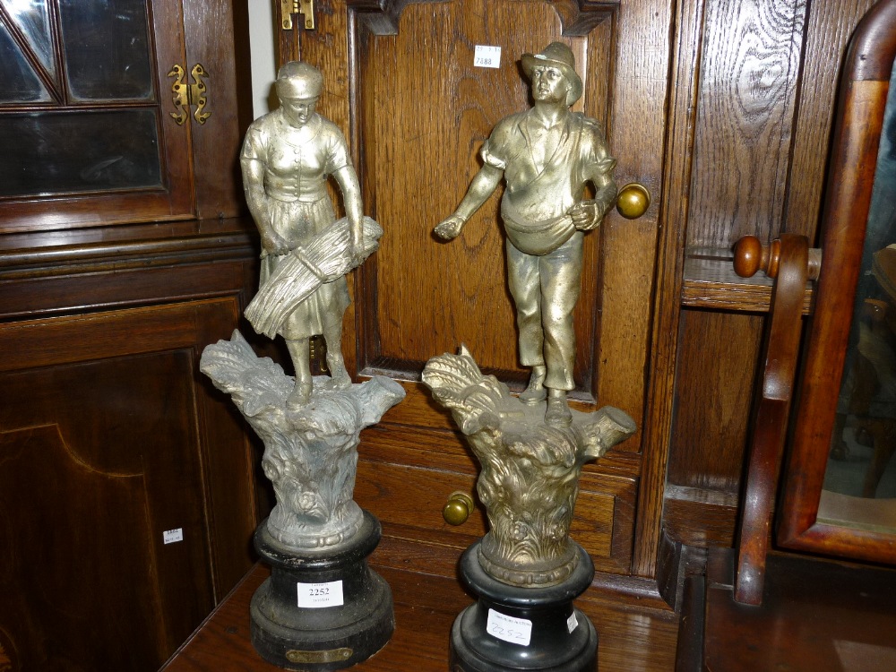 Pair of French silvered spelter figures of farm workers, inscribed ' Les Semeur ' and ' La