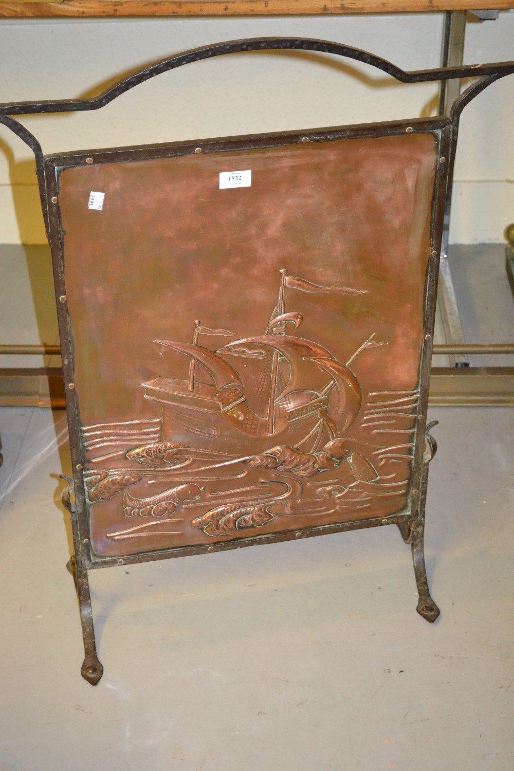 Newlyn type wrought iron and embossed copper firescreen decorated with a scene depicting a 16th