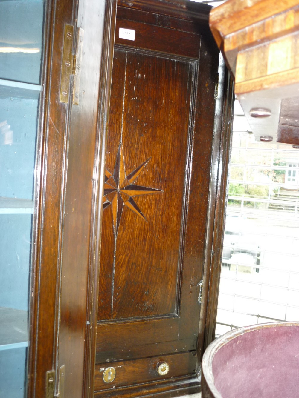 18th Century oak hanging corner cabinet with single panel door bearing a star inlay above a single