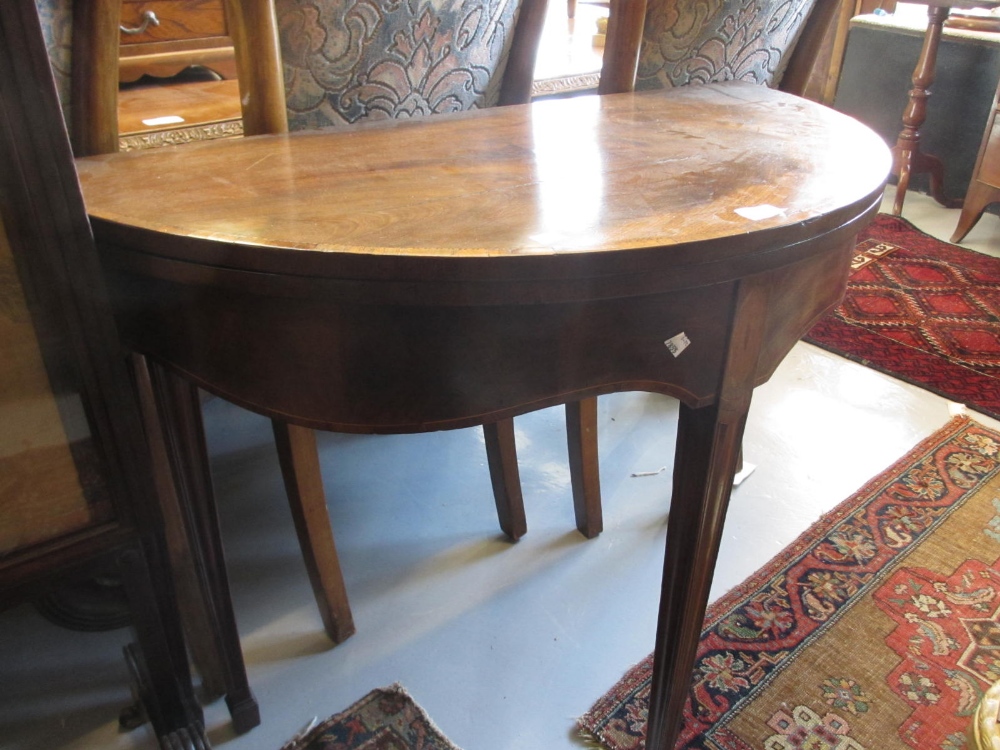 George III figured mahogany D-shaped fold-over tea table, the crossbanded and chequer line inlaid