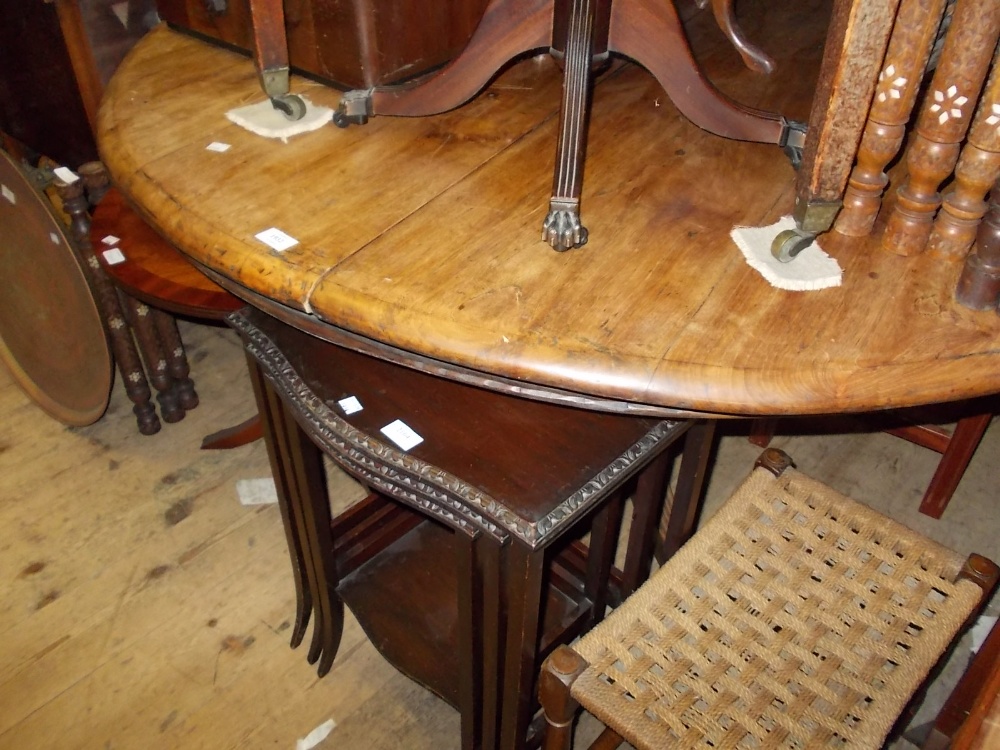 20th Century Indonesian circular hardwood extending dining table with integral single extra leaf