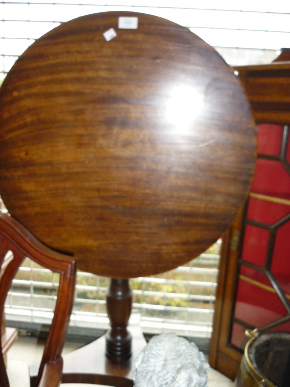 Regency mahogany circular pedestal table with turned column support and tri-form base