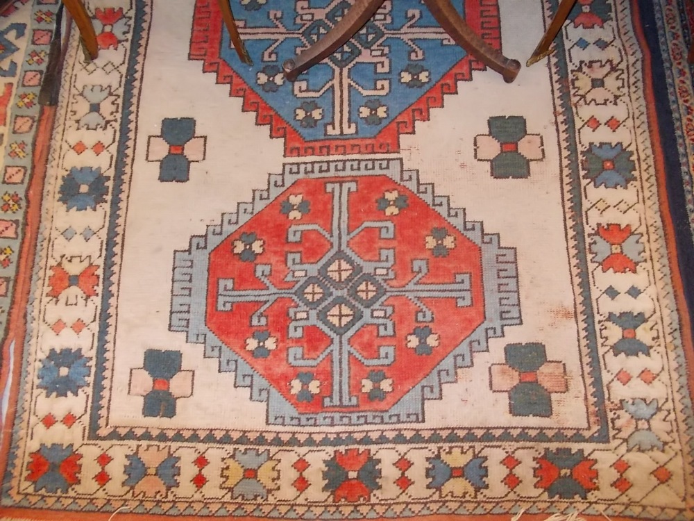 Turkish Caucasian design hook medallion rug with borders on cream and orange ground