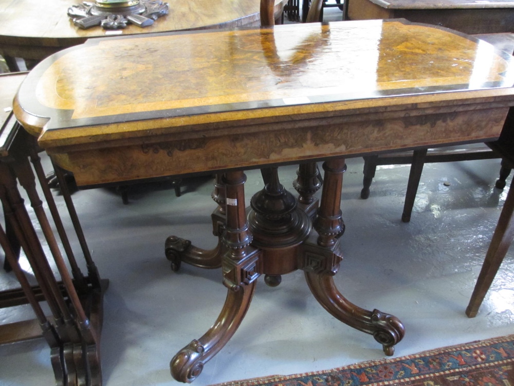 Victorian figured walnut line inlaid and crossbanded fold-over card table on a quadruped base with