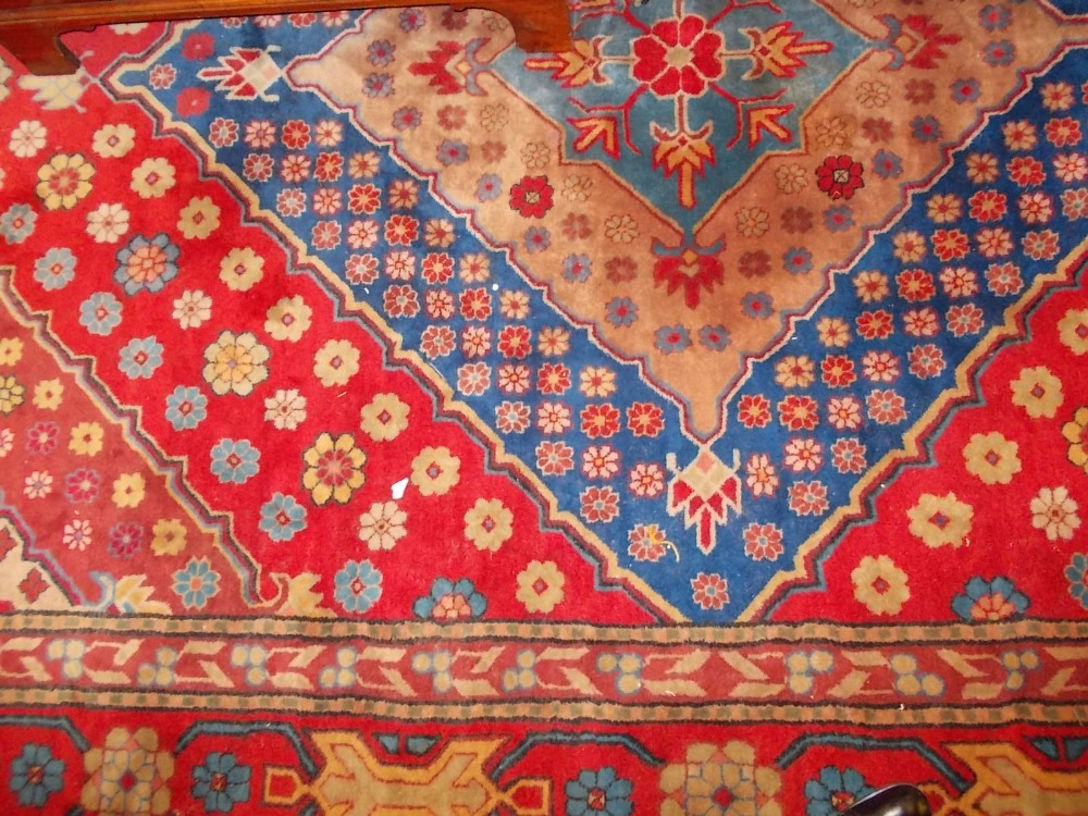 20th Century Turkish carpet with medallion and all-over stylised floral design on a cerise ground