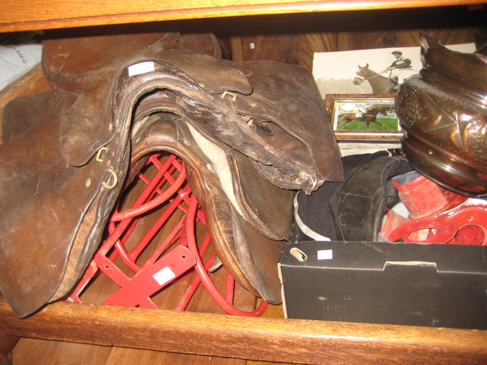 Group of six various leather saddles (a/f) together with a box containing a quantity of various