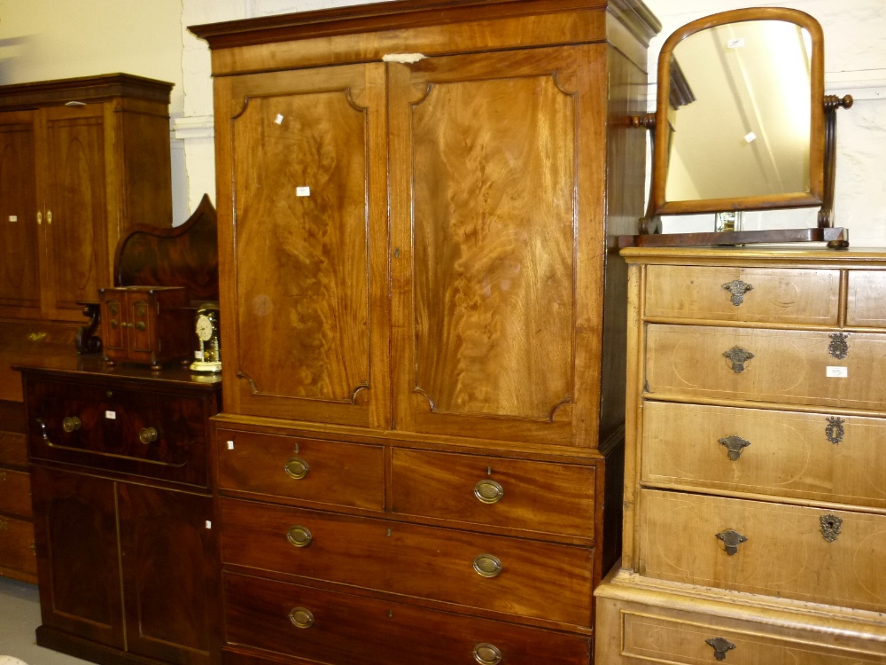 George III mahogany linen press, the moulded cornice above a pair of panelled doors enclosing