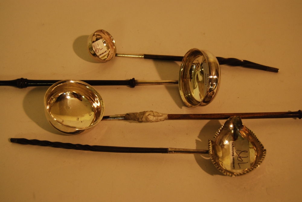 Four various 18th and 19th Century silver and white metal toddy ladles (two a/f)