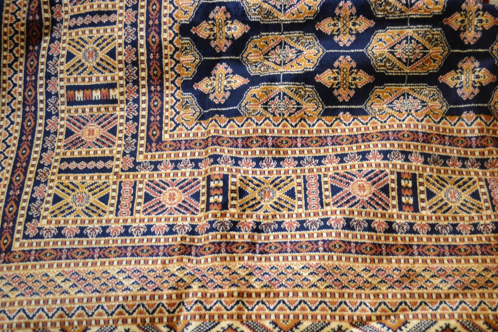 Bokhara style carpet with blue ground, 2.3m x 1.6m