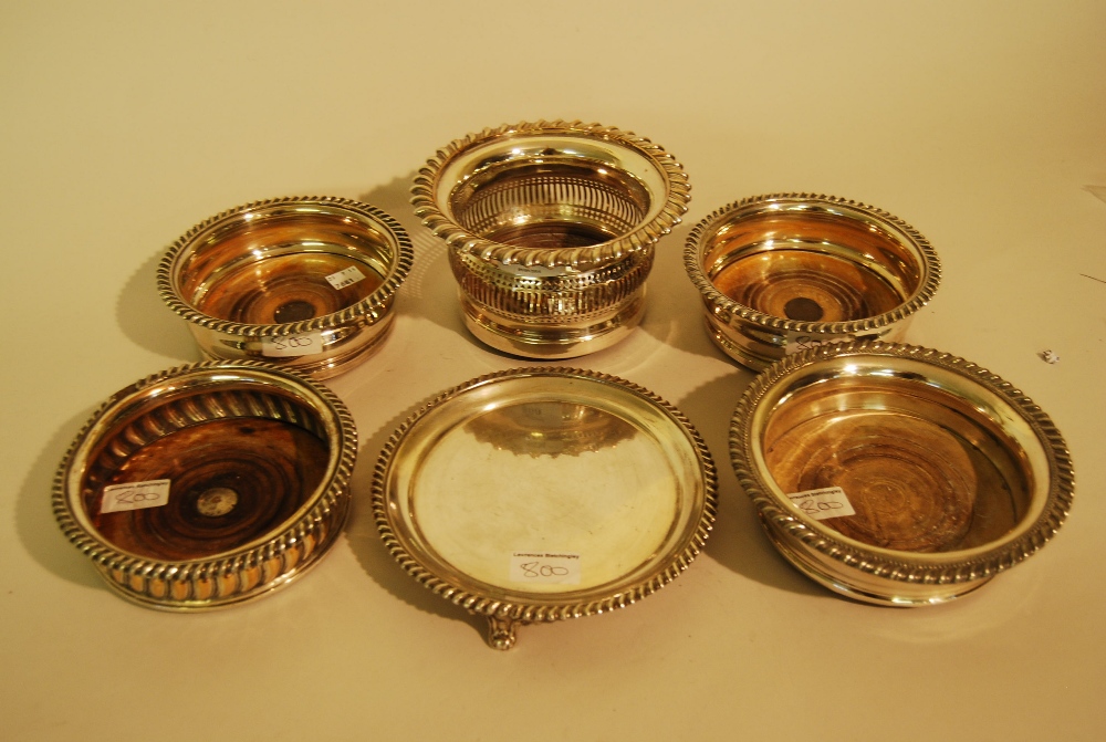 Group of five various 19th Century plated bottle coasters together with a small plated card salver