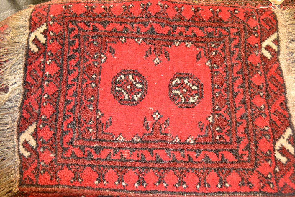 Two small Persian style rugs with red ground and borders