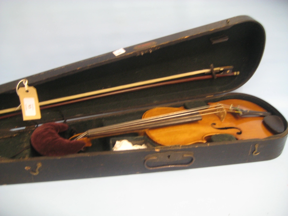 Three quarter size violin having two piece back in fitted wooden case with bow