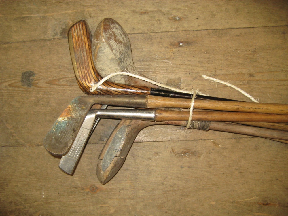Collection of various hickory shafted golf clubs