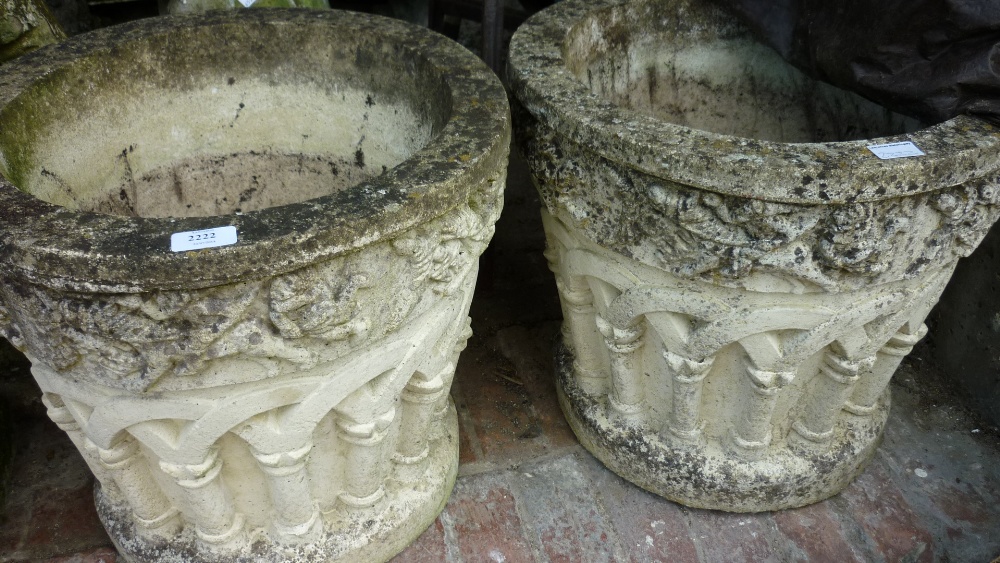 Pair of cast concrete garden pots decorated in relief with cloisters