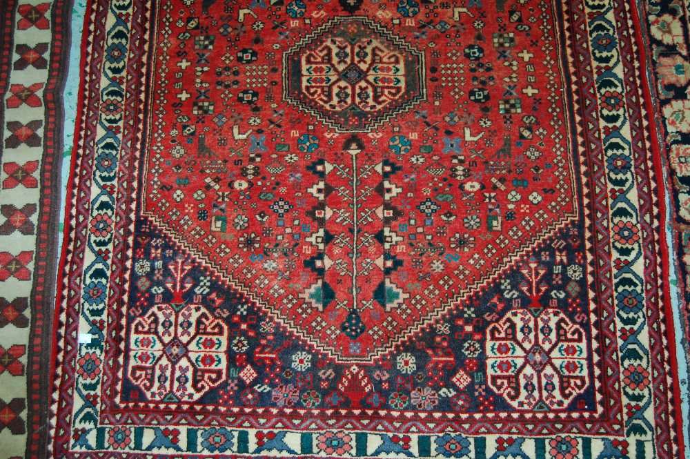 20th Century Qashqai rug with medallion and all-over floral design on a red ground with corner