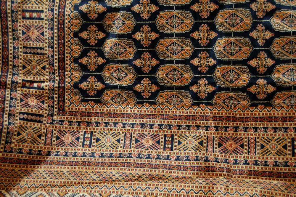 Bokhara style carpet with blue ground, 2.3m x 1.6m