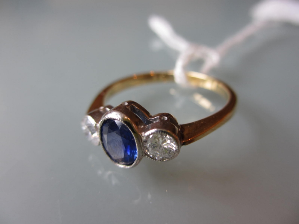 18ct yellow gold ring set central oval sapphire flanked by diamonds