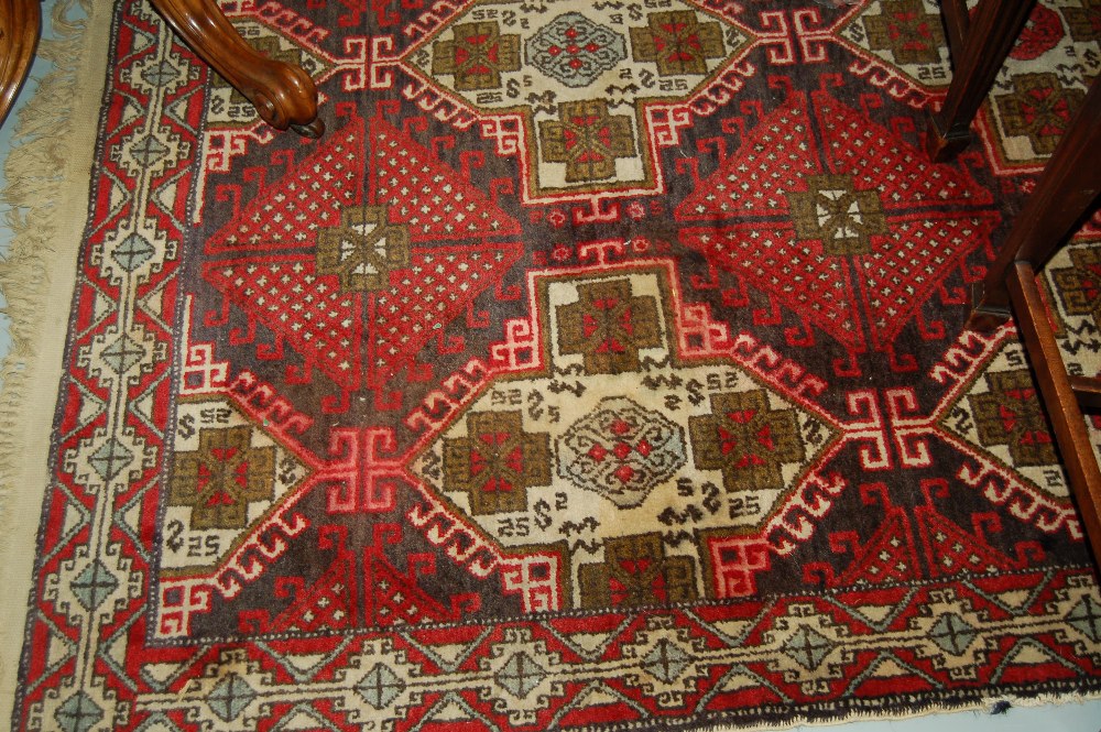 Turkish rug of Caucasion design with multiple hooked medallions and narrow border