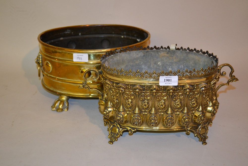 Brass embossed two handled flower trough together with an oval brass flower trough with lions head